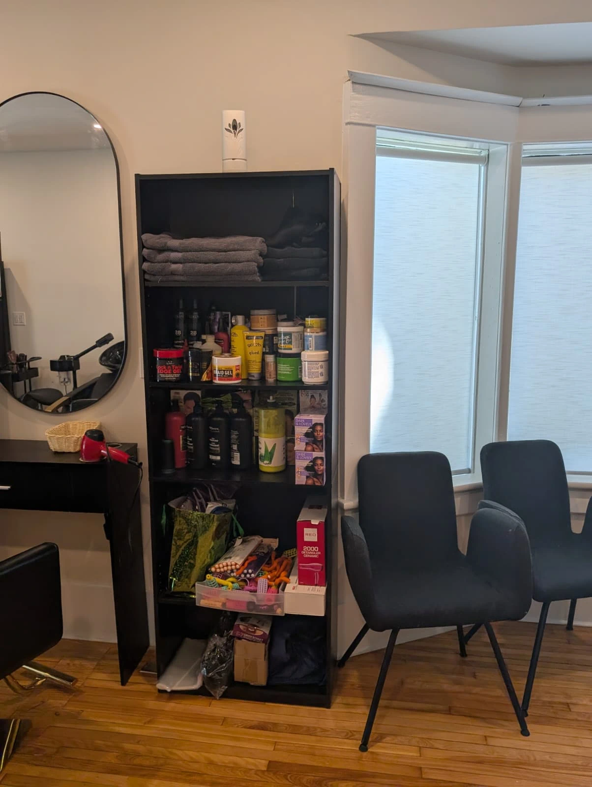 A salon retail display featuring high-quality wigs and hair bundles available directly in-salon for custom installations.