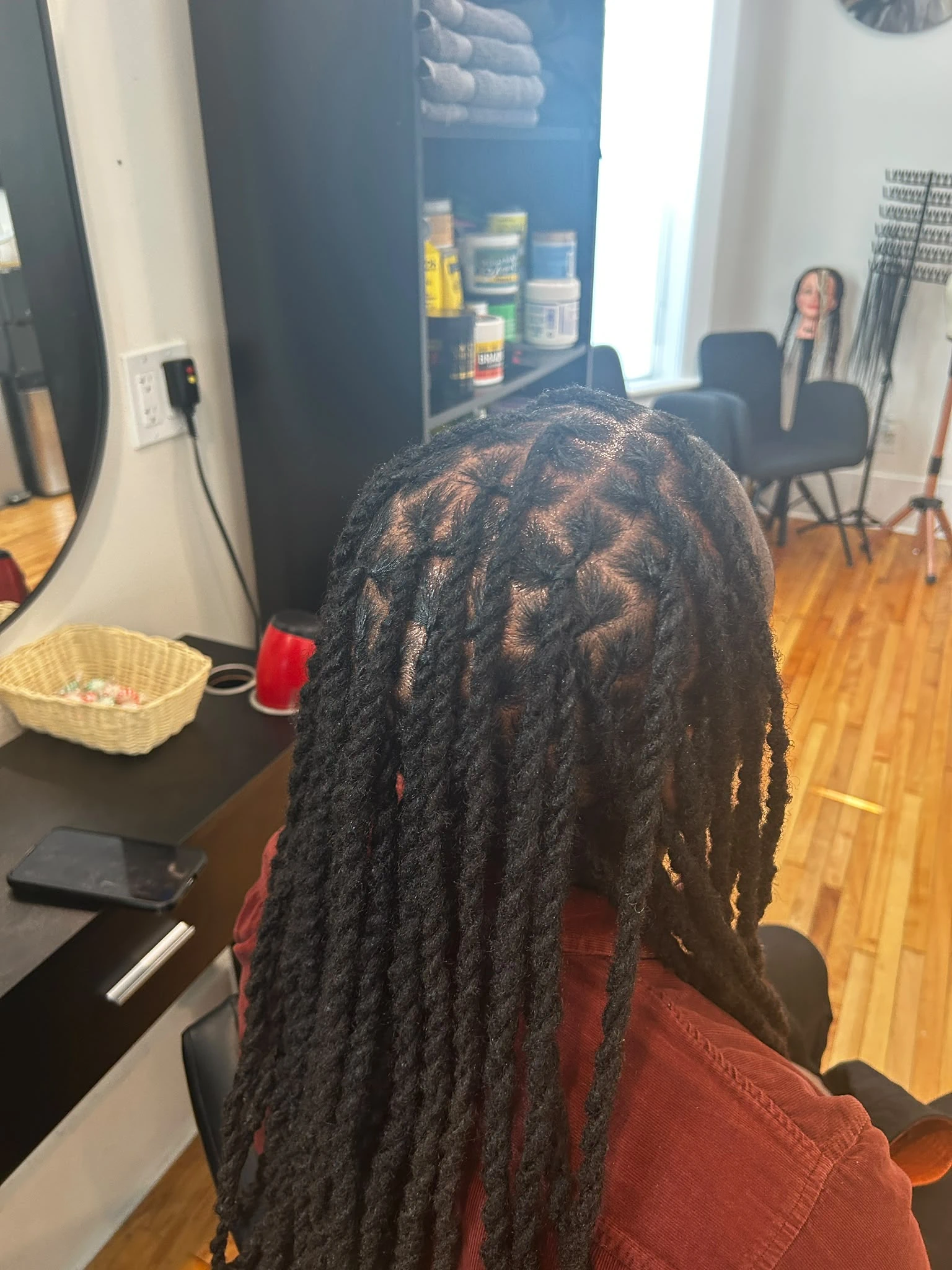 Close-up of a client's freshly maintained, thick natural locs, demonstrating our expertise in loc care and damage repair.